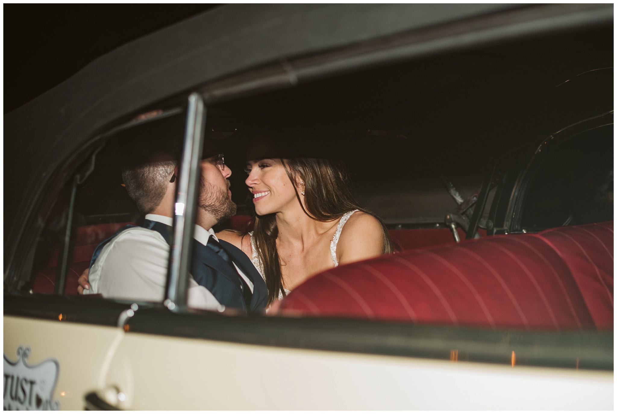 bride and groom exit in vintage car