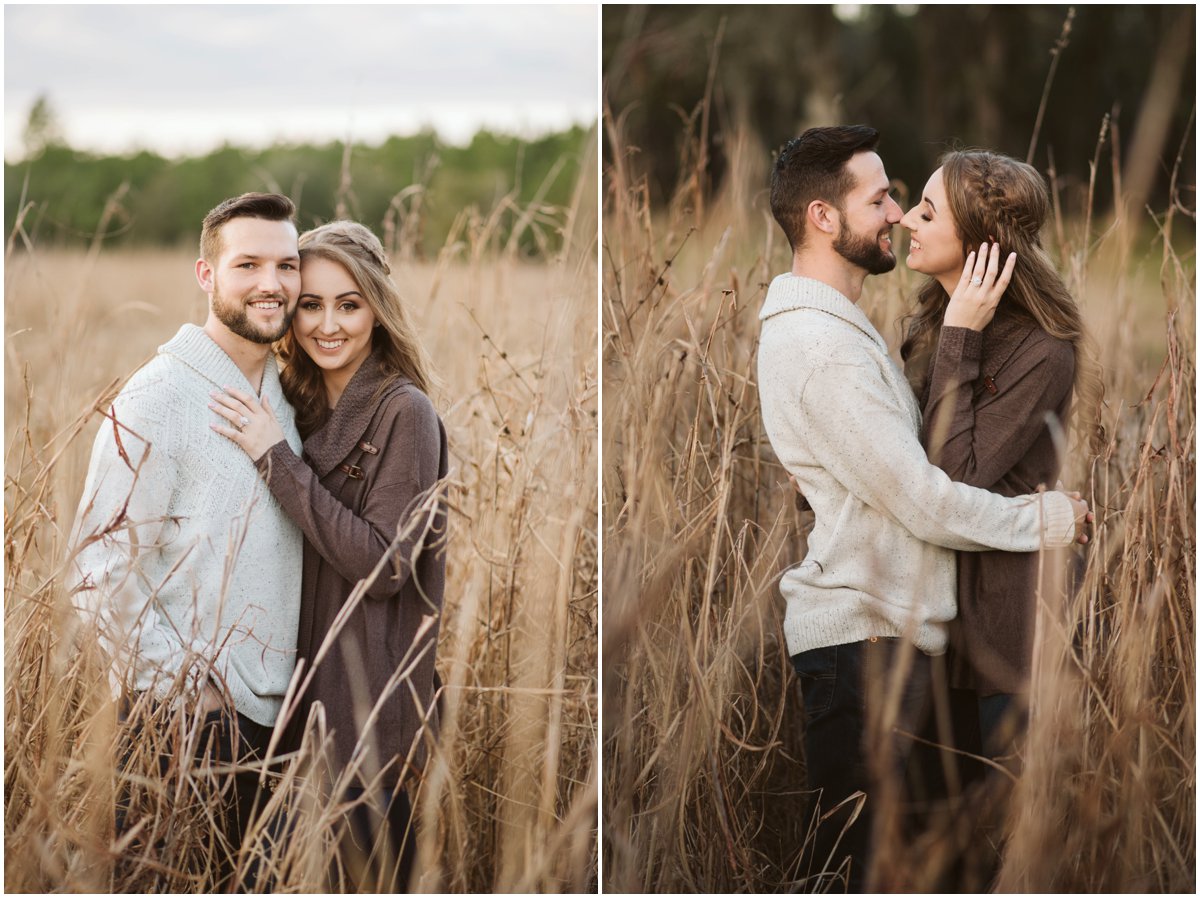 man and woman snuggling in tall grass wearing neutral colors