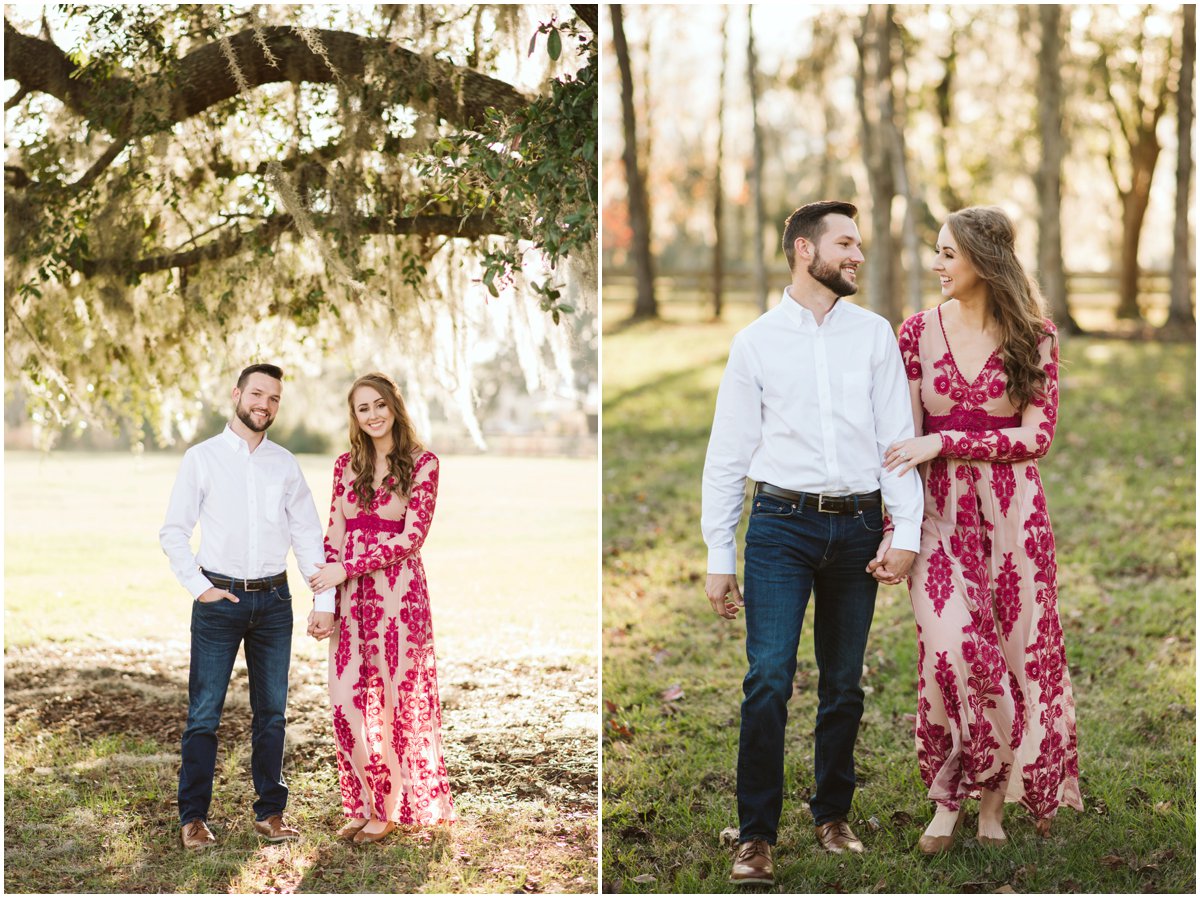 engaged couple standing under mossy oak trees holding hands