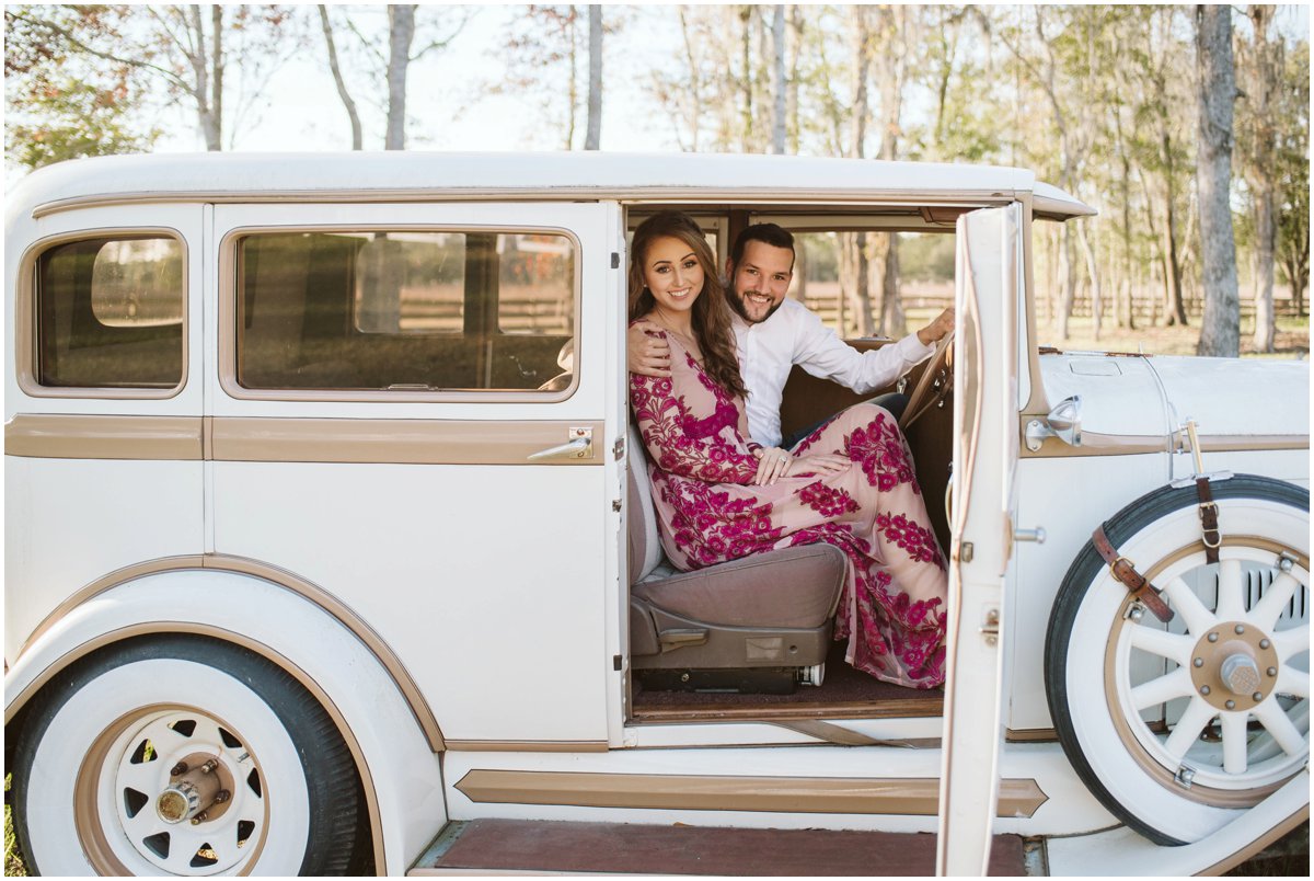 couple sitting inside of 1930 Essex Automobile at Belle Oaks barn