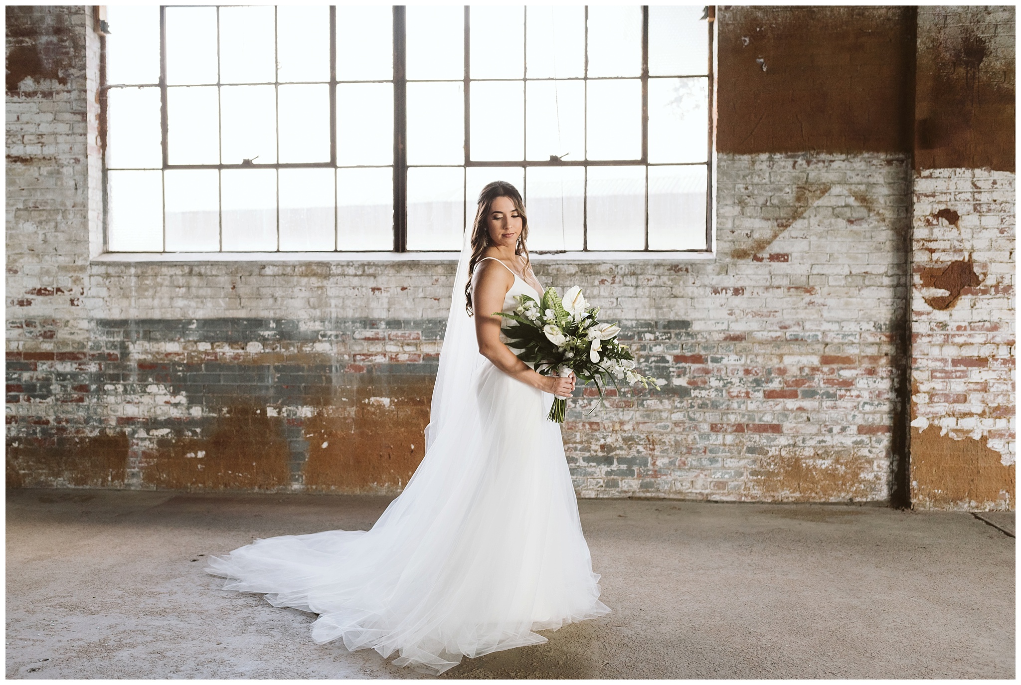 Modern bride posing at the Glass Factory in warehouse