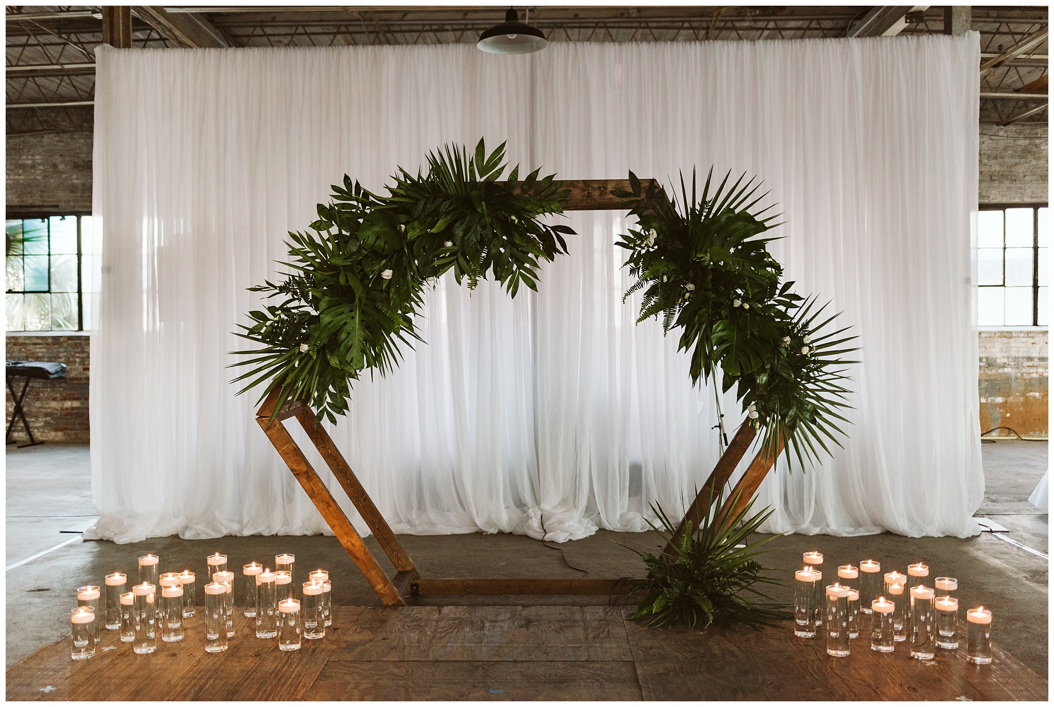 modern botanical candle lit ceremony arch 