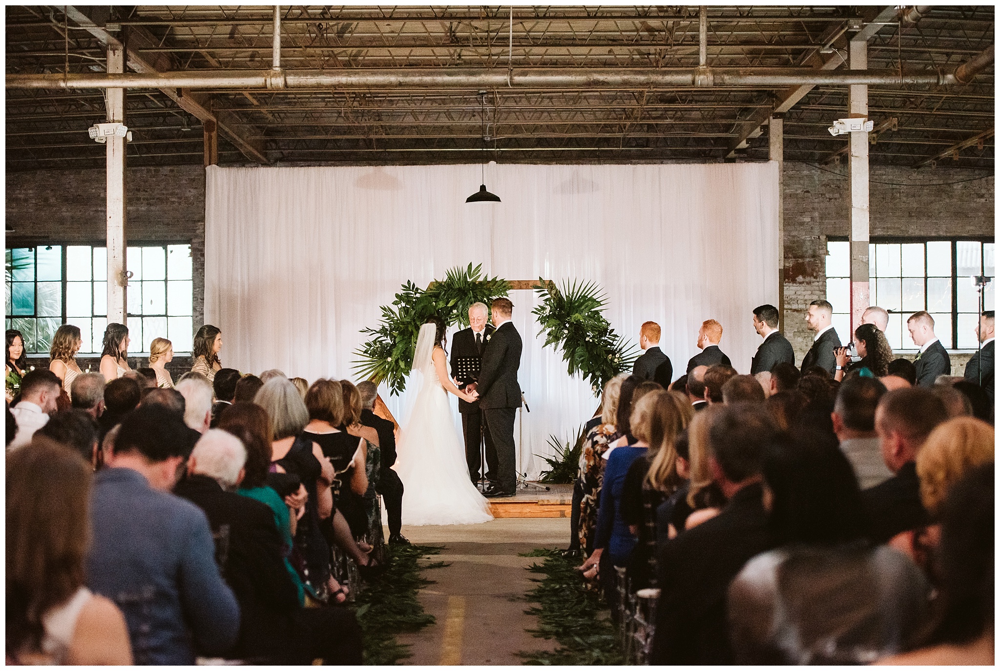 couple getting married at the glass factory during ceremony