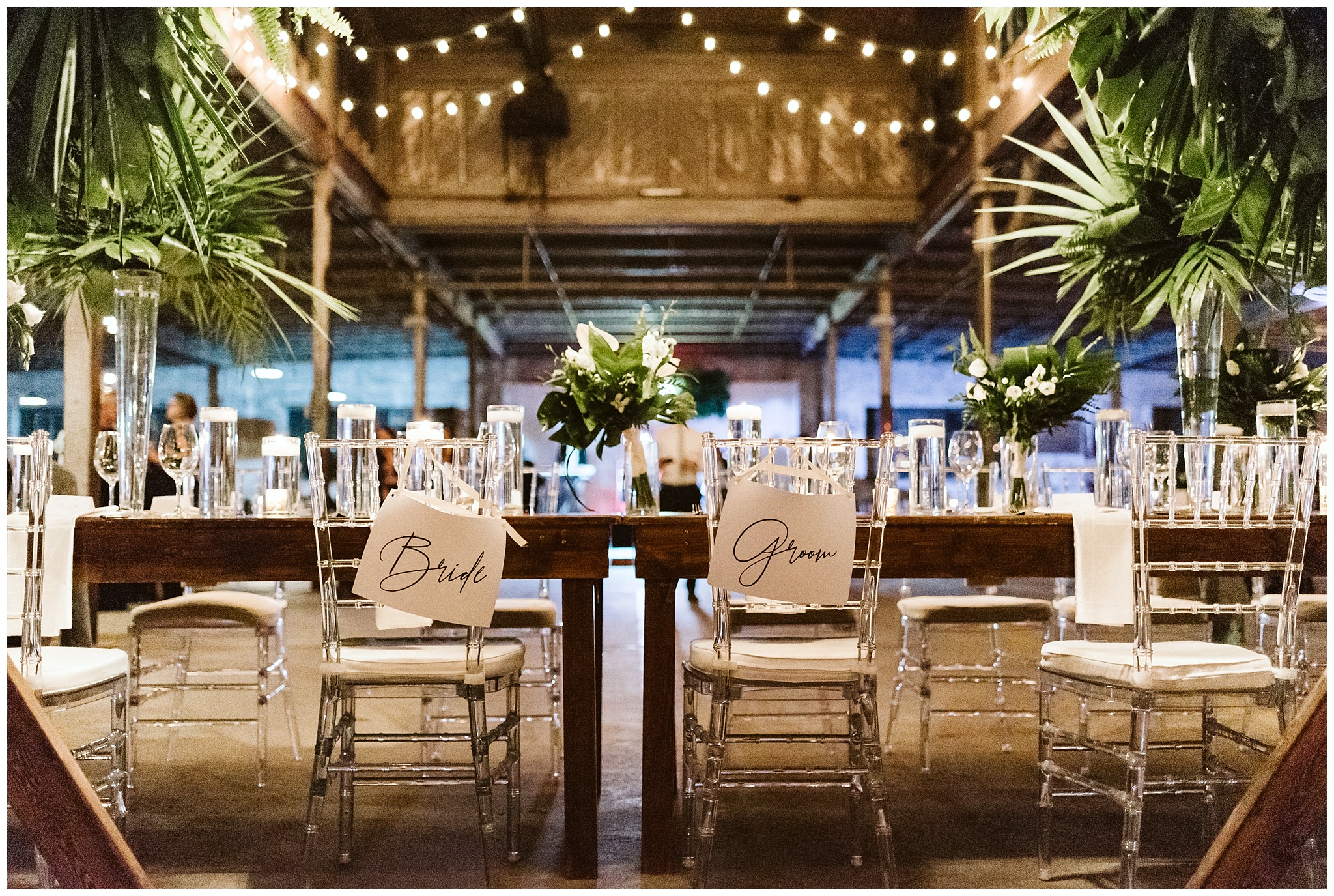 lights strung at reception at the glass factory in jacksonville fl with clear chairs